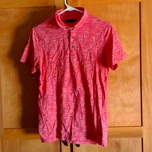 A light pink salmon colored polo shirt